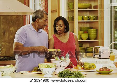 Mature couple talking in the kitchen View Large Photo Image Stock Image - Mature couple talking in the kitchen. Fotosearch