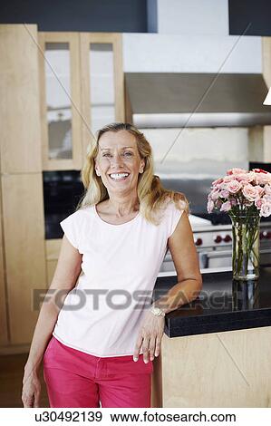 Portrait of a mature woman smiling View Large Photo Image Stock Photo - Portrait of a mature woman smiling. Fotosearch