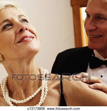 Close-up of a mature man and a senior woman smiling View Large Photo Image Stock Photograph - Close-up of a mature man and a senior woman smiling. Fotosearch