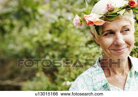 Close-up of a senior woman smiling and looking away View Large Photo Image Stock Photograph - Close-up of a senior woman smiling and looking away. Fotosearch