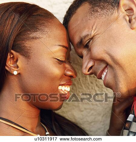 Stock Photo - Close-up of a couple smiling. Fotosearch