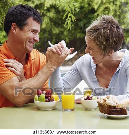 Stock Photo - Close-up of a mature couple arm wrestling. Fotosearch