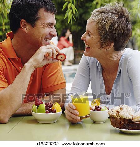 Stock Image - Close-up of a mature couple having breakfast. Fotosearch