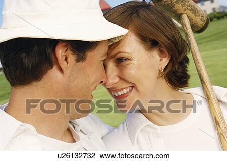 Close-up of a mid adult couple looking at each other and smiling View Large Photo Image Stock Image - Close-up of a mid adult couple looking at each other and smiling. Fotosearch