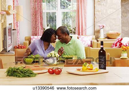 Mature couple eating salad and looking at each other View Large Photo Image Stock Photograph - Mature couple eating salad and looking at each other. Fotosearch