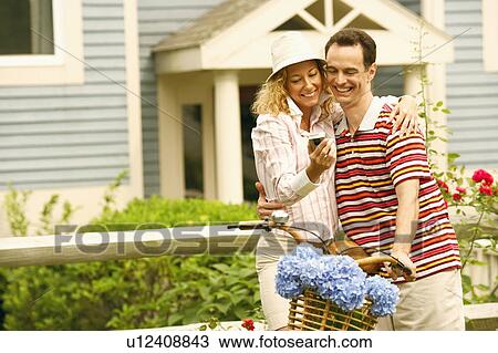 Mature couple looking at a mobile phone View Large Photo Image Stock Image - Mature couple looking at a mobile phone. Fotosearch