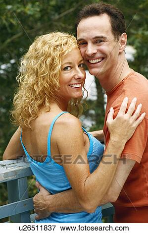 Portrait of a mature couple embracing each other and smiling View Large Photo Image Stock Photo - Portrait of a mature couple embracing each other and smiling. Fotosearch