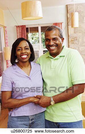 Portrait of a mature couple holding hands and smiling View Large Photo Image Stock Photography - Portrait of a mature couple holding hands and smiling. Fotosearch
