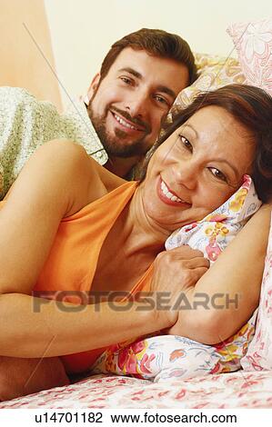 Portrait of a mature couple lying in bed View Large Photo Image Stock Image - Portrait of a mature couple lying in bed. Fotosearch