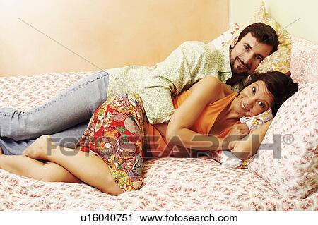 Portrait of a mature couple lying in bed View Large Photo Image Stock Image - Portrait of a mature couple lying in bed. Fotosearch