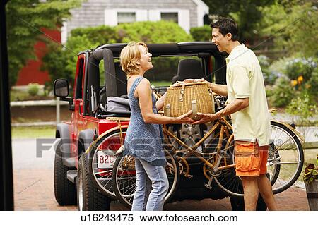 Stock Photography - Side profile of a mature couple holding a basket. Fotosearch