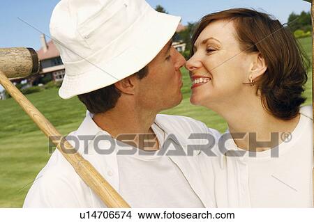 Close-up of a mid adult couple nuzzling View Large Photo Image Picture - Close-up of a mid adult couple nuzzling. Fotosearch