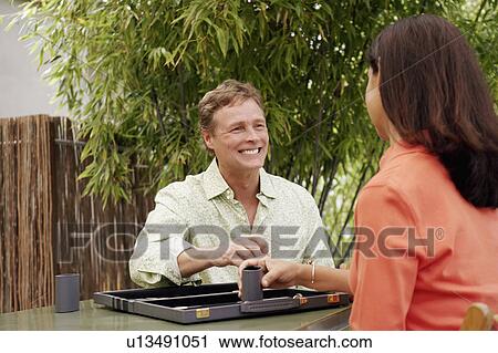 Mature couple playing backgammon View Large Photo Image Stock Image - Mature couple playing backgammon. Fotosearch