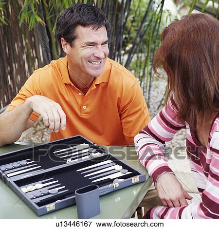 Mature couple playing backgammon View Large Photo Image Stock Photo - Mature couple playing backgammon. Fotosearch