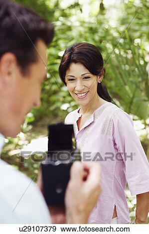 Mature man taking a picture of a mature woman View Large Photo Image Stock Photo - Mature man taking a picture of a mature woman. Fotosearch