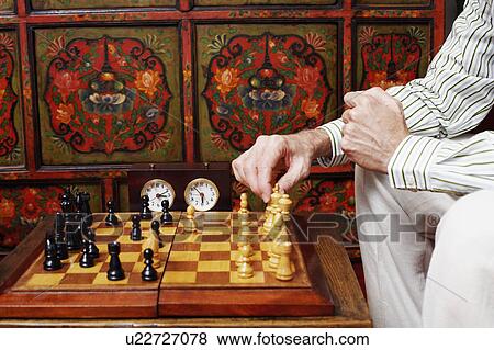 Mid section view of a man playing chess View Large Photo Image Stock Photo - Mid section view of a man playing chess. Fotosearch