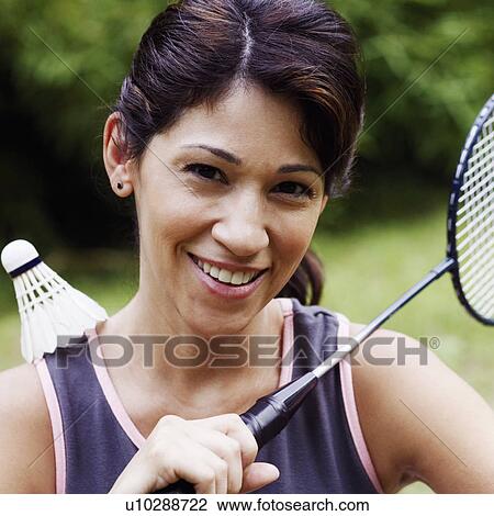 Stock Image - Portrait of a mature woman playing badminton. Fotosearch