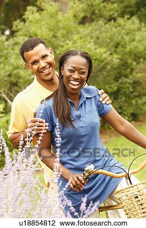 Portrait of a mid adult woman and a mature man cycling View Large Photo Image Stock Image - Portrait of a mid adult woman and a mature man cycling. Fotosearch