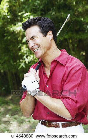 Side profile of a mature man holding a golf club View Large Photo Image Stock Image - Side profile of a mature man holding a golf club. Fotosearch