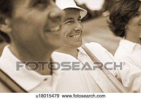 Stock Photo - Close-up of a mature man and a mid adult couple. Fotosearch