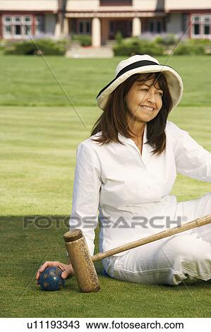 Close-up of a mature woman holding a croquet mallet and a ball View Large Photo Image Stock Image - Close-up of a mature woman holding a croquet mallet and a ball. Fotosearch