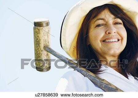 Low angle view of a mature woman holding a croquet mallet View Large Photo Image Stock Photo - Low angle view of a mature woman holding a croquet mallet. Fotosearch