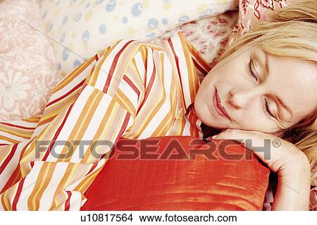 Picture - Close-up of a mature woman sleeping on the bed. Fotosearch