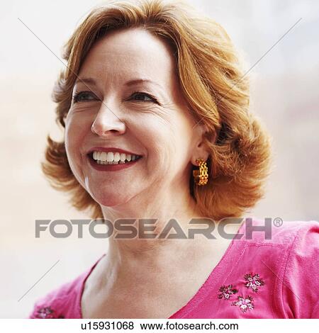 Stock Photo - Close-up of a mature woman smiling and looking up. Fotosearch