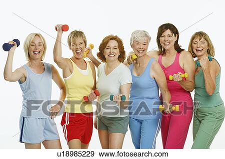 Portrait of a group of mature women holding dumbbells and smiling View Large Photo Image Stock Photo - Portrait of a group of mature women holding dumbbells and smiling. Fotosearch