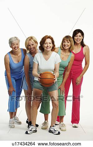 Portrait of a mature woman holding a basketball with her four friends standing behind her View Large Photo Image Picture - Portrait of a mature woman holding a basketball with her four friends standing behind her. Fotosearch