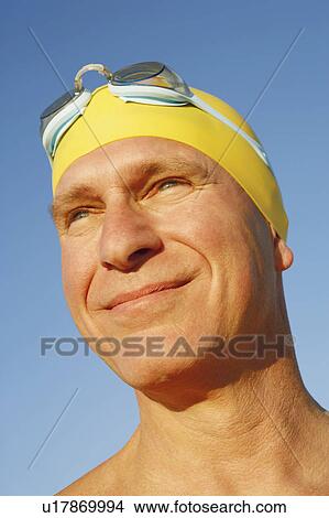Picture - Close-up of a mature man smirking. Fotosearch