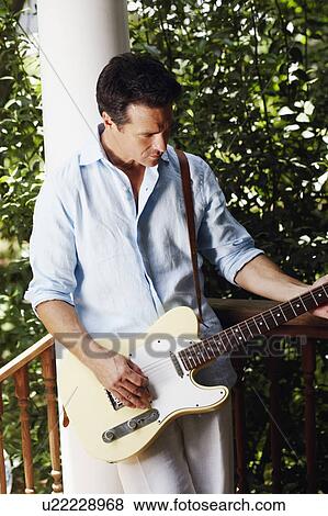Mature man playing the guitar View Large Photo Image Stock Photo - Mature man playing the guitar. Fotosearch