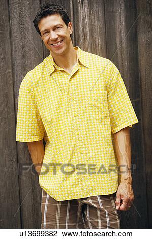 Portrait of a mature man standing and smiling View Large Photo Image Stock Image - Portrait of a mature man standing and smiling. Fotosearch
