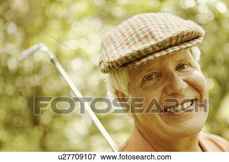 Portrait of a mature man with a golf club View Large Photo Image Stock Photo - Portrait of a mature man with a golf club. Fotosearch