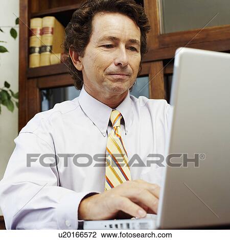 Stock Image - Businessman using a laptop. Fotosearch