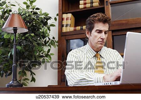 Stock Photo - Businessman using a laptop. Fotosearch