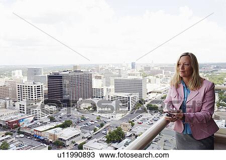 Stock Image - Businesswoman holding a personal data assistant. Fotosearch