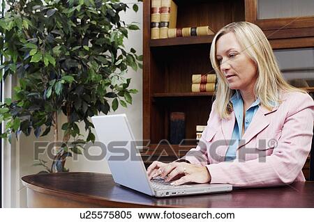 Businesswoman working on a laptop View Large Photo Image Stock Photography - Businesswoman working on a laptop. Fotosearch