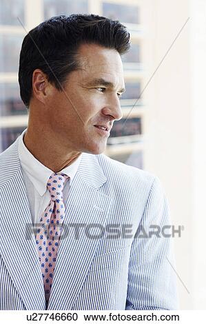Close-up of a businessman looking sideways View Large Photo Image Stock Image - Close-up of a businessman looking sideways. Fotosearch