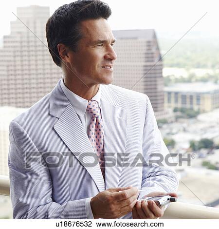 Close-up of a businessman using a personal data assistant View Large Photo Image Stock Image - Close-up of a businessman using a personal data assistant. Fotosearch