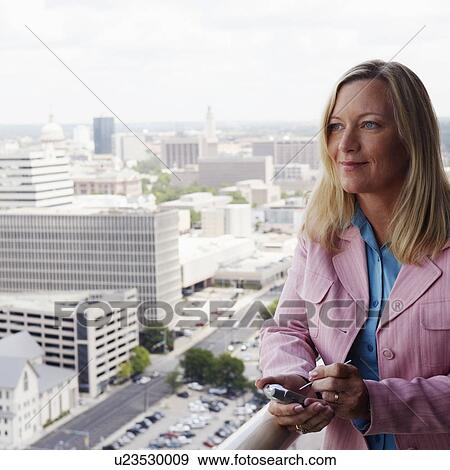 Close-up of a businesswoman holding a personal data assistant View Large Photo Image Stock Photo - Close-up of a businesswoman holding a personal data assistant. Fotosearch