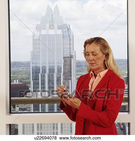 Close-up of a businesswoman using a personal data assistant View Large Photo Image Stock Photo - Close-up of a businesswoman using a personal data assistant. Fotosearch