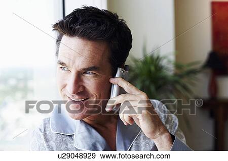 Stock Photo - Close-up of a mature man talking on a mobile phone. Fotosearch