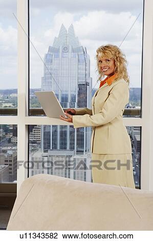 Portrait of a businesswoman using a laptop View Large Photo Image Stock Image - Portrait of a businesswoman using a laptop. Fotosearch