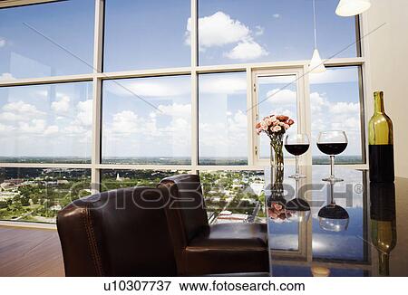Close-up of two wine glasses with a wine bottle and a flower vase on the table View Large Photo Image Stock Photo - Close-up of two wine glasses with a wine bottle and a flower vase on the table. Fotosearch