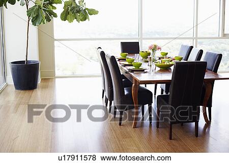 Dining table with empty chairs in a dining room View Large Photo Image Stock Photo - Dining table with empty chairs in a dining room. Fotosearch