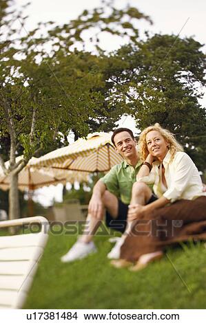 Low angle view of a mature couple sitting together View Large Photo Image Picture - Low angle view of a mature couple sitting together. Fotosearch
