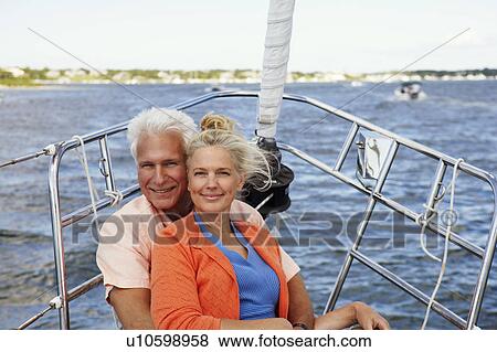 Portrait of a mature man embracing a mature woman from behind in a boat and smiling View Large Photo Image Stock Photo - Portrait of a mature man embracing a mature woman from behind in a boat and smiling. Fotosearch