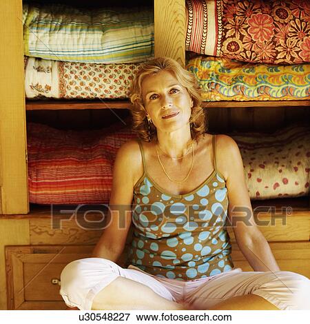 Stock Photo - Portrait of a mature woman sitting. Fotosearch