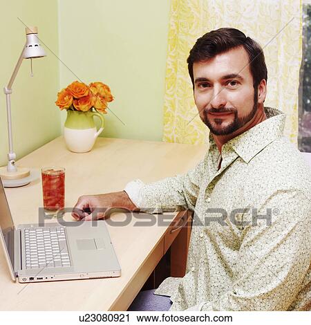 Side profile of a mature man sitting in front of a laptop View Large Photo Image Stock Image - Side profile of a mature man sitting in front of a laptop. Fotosearch
